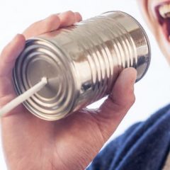 Man talking into a can with a string