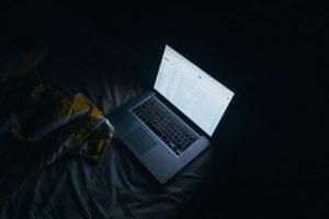 Lit laptop in a dark room